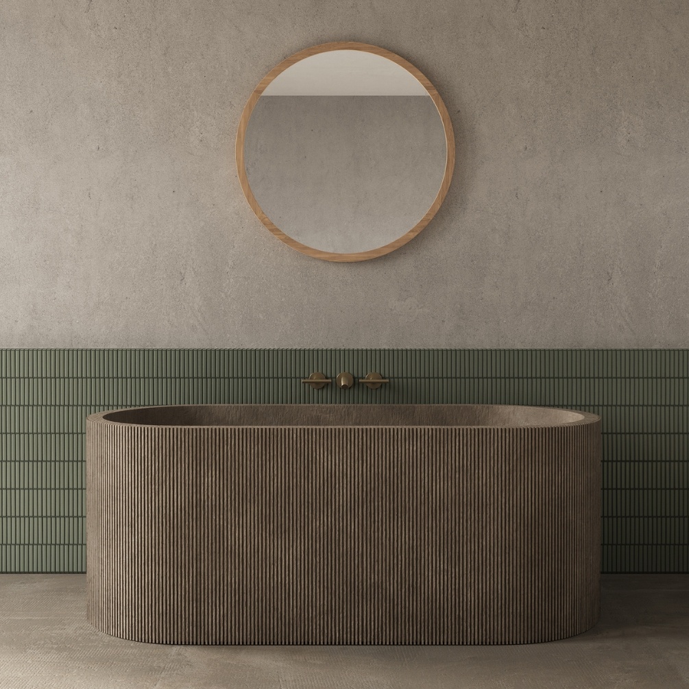 Product lifestyle image of the Origins Living Kenji Round 800mm x 800mm Mirror mounted on a wall in-front of a brown fluted edge freestanding bath KNJ-00D080-BA
